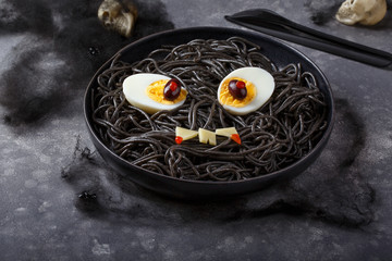 Scary halloween food.  Black spaghetti  with eggs and cheese.