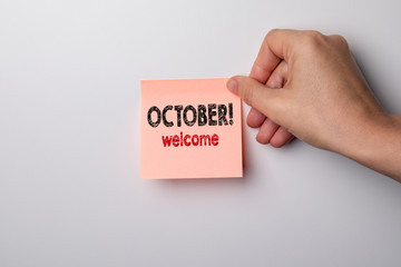 October, welcome.  Sticky note on a white background