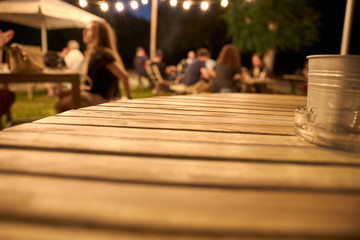 view of a wooden table on the terrace of a bar