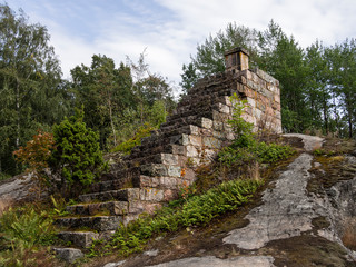 Fototapeta na wymiar Stairs leading to nowhere, maybe a stairway to heaven. Stone stairs that stop at nothing. Shot in Vallisaari, Helsinki, FInland
