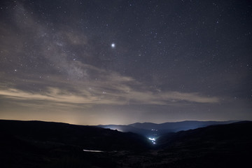 Obraz premium image of the milky way galaxy over a small town