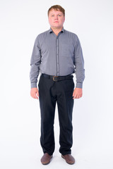 Full body shot of overweight businessman looking at camera
