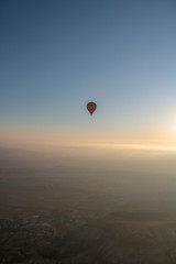 hot air balloon isolated on the blue sky at sunrise