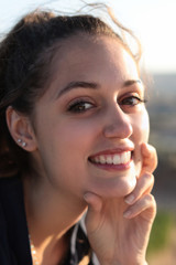 close portrait of young woman smiling to camera