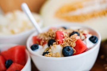 bowl with cereal, fruits and yogurt - healthy breakfast