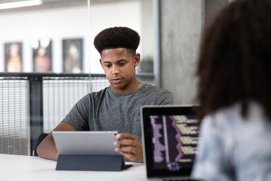 African American male student coding in class