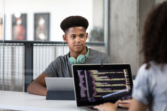 African American male student coding in class