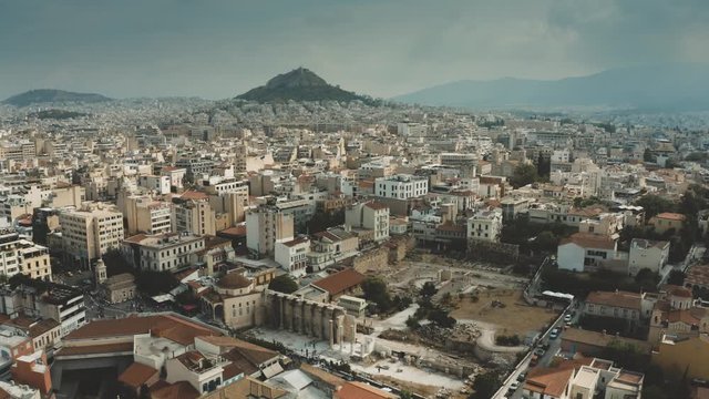 Aerial view of the cityscape of Athens, Greece. Flight from the Acropolis towards the Lycabettus Hill