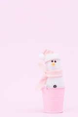 Christmas snowman on a delicate pink background with copy space.Xmas concept.