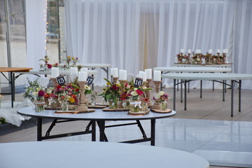 Hall after the wedding party with flowers and candles on the table