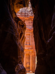 Front facade of the treasury temple of Petra, Jordan, seen from dark sandstone cliffs