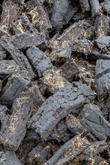 Piles of cut peat in the Hebridean countryside