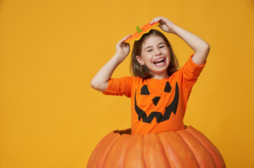 little girl in pumpkin costume