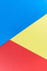 Texture paper yellow, red and blue. Background image. Minimalism, flat lay, place for text.