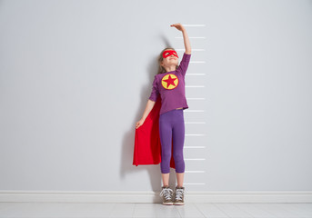 child is playing superhero