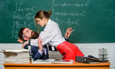 Protecting himself. Sexy woman abusing bearded man in class. Man victim in harassing relationship....