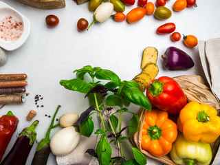 Italian food ingredients background with vegetables, salt, spices and herbs, cheese, olive oil, basil, bell peppers, eggplant and tomatoes, copy space
