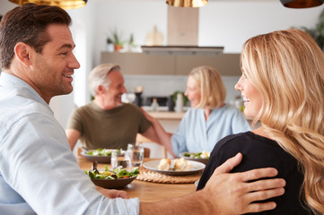Introducing Boyfriend Or Girlfriend To Senior Parents At Meal Around Table At Home Together