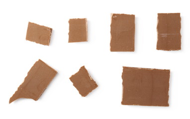 Chocolate pieces, bars isolated on white background, top view