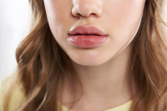 Lovely teen girl demonstrating her beautiful full lips