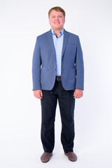 Full body shot of happy overweight businessman in suit smiling