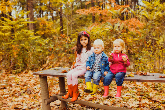 Family day in autumnal park, group of kids