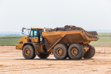 Industrial Dump Truck Vehicle Moving Earth Property Development Countryside Landscape.
