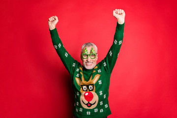 Photo of successful having great good mood achieving goal with beaming smile old guy raising hands up feeling music rhythm celebrating x-mas isolated bright color background
