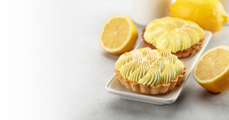 Tartlets with lemon cream on a white table.