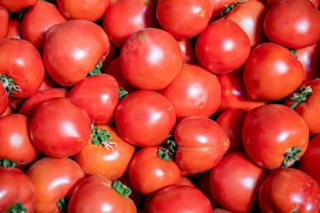 Pile of red ripe tomatoes close-up at the market