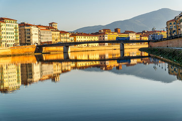 Sunset on the banks of the Arno River, Pisa, Italy.
