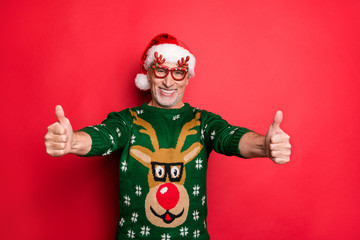 Ugly jumper pullover is my power in competition concept. Photo of cheerful excited with beaming smile mature guy making finger up symbol wear green clothes isolated background