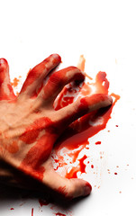 Male bloodied hand on a white background with splashes and drops of blood.