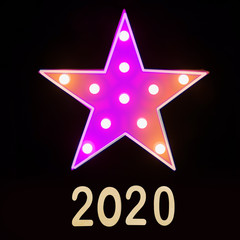 Obraz premium Neon star on black. Happy New Year 2020. Xmas party. Christmas celebration.