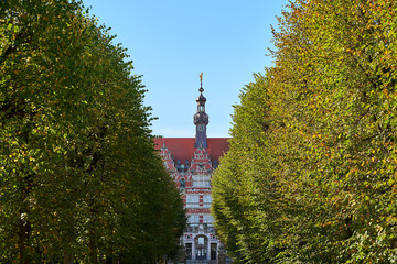 The main building of Gdansk University of Technology or Politechnika Gdanska among trees on the approaching alley