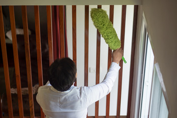 asian middle aged domestic helper woman cleaning apartment, doing housework, housekeeping service