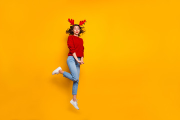 Fototapeta na wymiar Full size photo of cheerful lady jumping high xmas party wear knitted pullover isolated yellow background