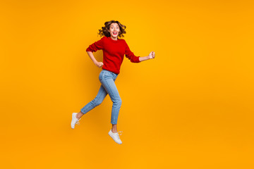 Fototapeta na wymiar Full size photo of funny lady jumping high rushing shopping wear knitted sweater isolated yellow background