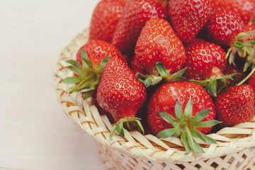 Plate of strawberry on pink wooden background