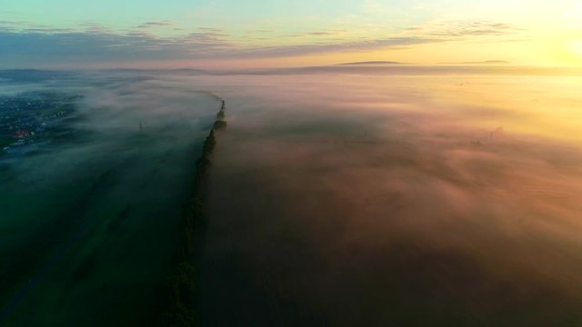 Magnificent aerial flight through landscape during golden hour when sunlight turns magical.