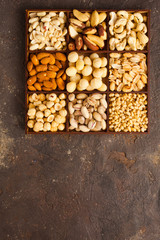 Variety of nuts in wooden box from top view
