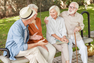 Joyful senior people chatting and laughing outdoors