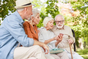 Senior people using modern cellphone on the street