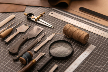 Leather craft tools on a cutting mat, flat lay
