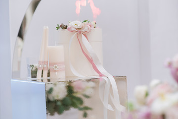 Beautiful wedding attribute for the European marriage ceremony in white and pink. Big white gift box.