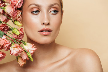 Fototapeta na wymiar Blonde woman posing naked with flowers.