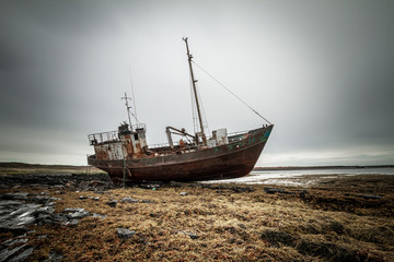 Abandoned ship on the coast of the Arctic Ocean.