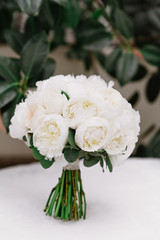 A beautiful bouquet for brides made of white round-shaped pines with natural stems