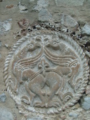 Medieval round stone decoration with bird representation