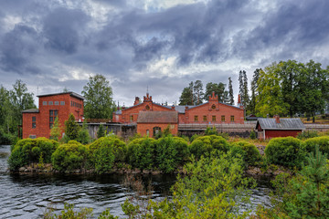 Old paper mill buildings of red brick at overcast autumn day. Verla Groundwood and Board Mill - Museum. Finland